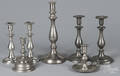 Seven pewter candlesticks