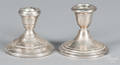 Two pairs of sterling silver weighted candlesticks