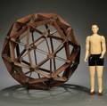 Mahogany Geodesic Sphere and a Carved and Painted Wooden Articulated Figure of a Man