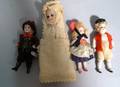 Three Small AllBisque Dolls and a Baby in Swaddling Clothes