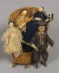 Four Early Wooden Dolls and a Woven Basket Chair