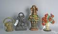 Four wrought iron door stops to include 3 baskets of flowers with paint decoration and one of a lion
