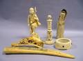 Three Chinese Carved Ivory Items a Japanese Peasant Fisherman Figure a European Carved Ornamental Base and an Eskimo Cribbage Board