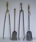 Four brass and iron fireplace tools