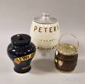 Two Tobacco Jars and a Ceramic Peters for Hot Chocolate Barrelform Urn