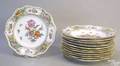 Twelve Dresden reticulated plates in a floral pattern with scalloped