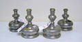 Two pair of bell base form pewter candlesticks