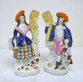 Pair of Staffordshire figures of a gentleman and his dog and a girl and her dog