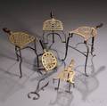 Five Pierced Brass and Iron Hearth Trivets and a Steel Sugar Nipper