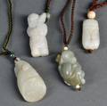 One Jade and Three Hardstone Pendants