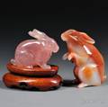 Two Carved Stone Rabbits and a Wood Stand
