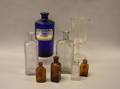 Cobalt Apothecary Jar Six Assorted Bottles and a Colorless Mold Blown Glass Goblet