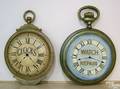 Two cast metal clockmakers trade signs late 19th c