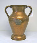 Large copper 2handled vessel with applied coatofarms and weighted base