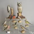 Nine carved and painted birds