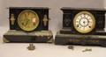 Two Neoclassical Black Painted Iron Mantel Clocks