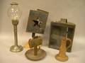 Two Tin Lighting Devices a Tin Parade Lantern a Pottery Candlestick and a Metal Lamp
