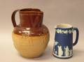 Wedgwood Dark Blue Jasper Dip Pitcher and a Doulton Lambeth Glazed Embossed Stoneware Jug