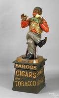 Painted cast zinc cigar store figure of a seated black man smoking a cigar