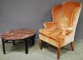 Chippendalestyle Upholstered Walnut Wing Chair and a Modern Oval Faux Marbletop Ebonized Wood Coffee Table