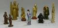 Nine Assorted Asian Figurines Ten Celadon Porcelain Items and a Trapped Bubble Art Glass Paperweight