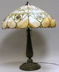 Leaded Slag Glass Floral Pattern Lamp Shade with a Patinated Cast Metal Table Lamp Base