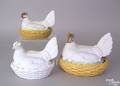 Three porcelain hens on nests