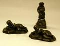 Wedgwood Black Basalt Figure and a Pair of Black Basalt Figures of a Reclining Baby Boy