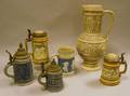 German Stoneware Jug Four Lidded Steins and a Stein