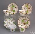Three strawberry creamware cups and saucers