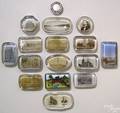 Fifteen glass souvenir paperweights