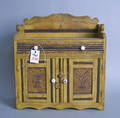 Doll jelly cupboard with painted surface and scalloped crest over a case with single drawer