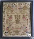 Wool on linen needlework dated 1855