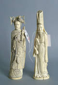 Two carved ivory figures one of a priest holding a gourd
