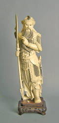 Massive carved ivory figure of a warrior with silver inlaid base
