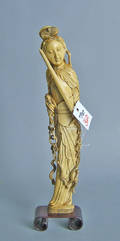 Carved ivory figure of a woman with a raised sword