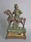 Chinese earthenware figure of a mounted warrior with green and auborgine glazing