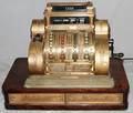 NATIONAL CASH REGISTER BRASS DESIGN W OAK BASE