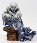 PORCELAIN ORIENTAL FIGURE OF A PRIESTLOHAN