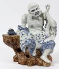 PORCELAIN ORIENTAL FIGURE OF A PRIESTLOHAN
