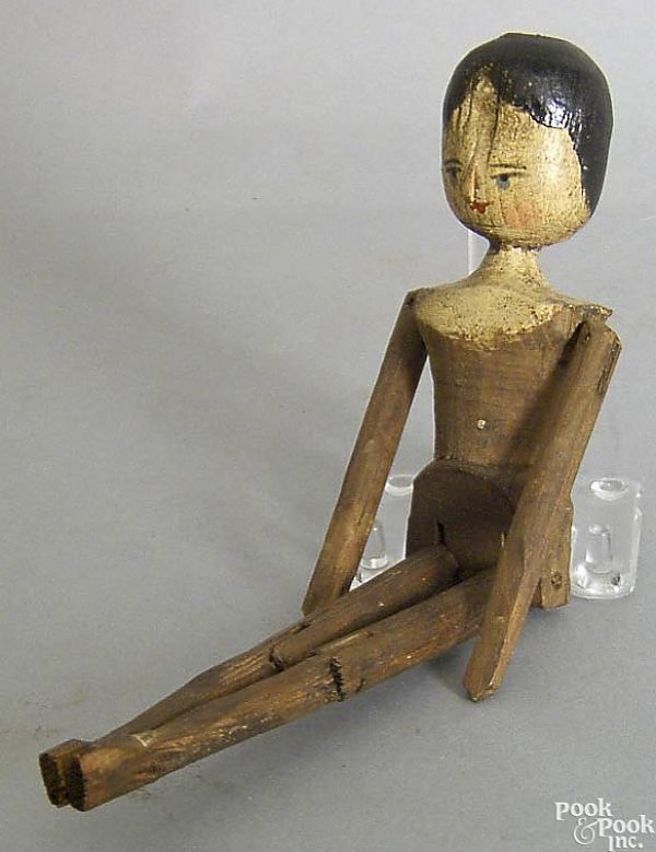 Realized price for Carved and articulated doll, 19th