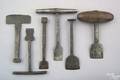 Six Pennsylvania wrought iron push and hammer style buttonhole cutters 19th c