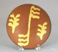 Small Pennsylvania redware plate 19th c