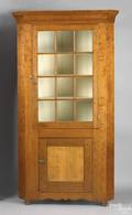 Pennsylvania cherry and tiger maple one piece corner cupboard ca 1825