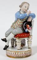 MEISSEN PORCELAIN FIGURE OF A SEATED BOY 19TH C