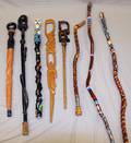 A COLLECTION OF 8 CARVED WALKING STICKS