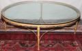 040110 GILT CAST IRON AND GLASS OVAL COFFEE TABLE