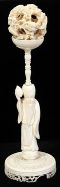 041262 CHINESE IVORY PUZZLE BALL ON A FIGURAL STAND