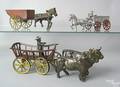 Three horse drawn cast iron farm vehicles