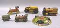 Twelve painted tin and iron toy trains and tractors earlymid 20th c